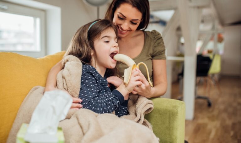 A kid eating banana